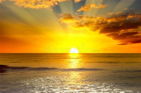Majestic Bright Sunrise Over Ocean And Light Waves Stock Photo Image