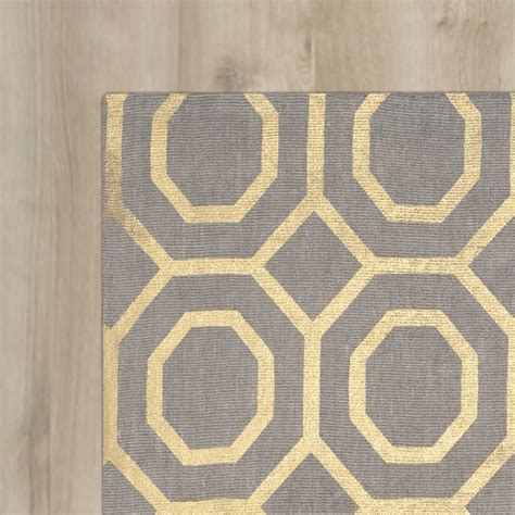 In our extensive gold rug collection, you will discover gold mixed with a wide range of colors, from black and brown to navy, grey, and beige that come rugs that use the color gold look great when paired with colors found in accents and furniture you already have in your home, such as navy, brown. Columbus Circle Hand-Loomed Grey/Gold Area Rug | Wayfair