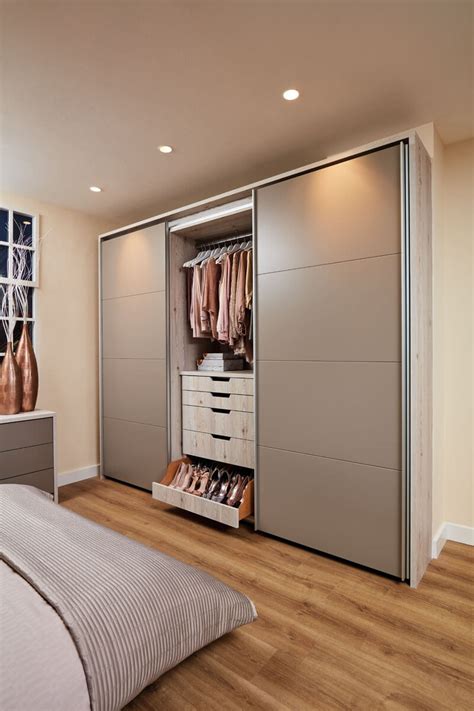 A Bedroom With A Bed Dresser And Sliding Closet Doors That Open To