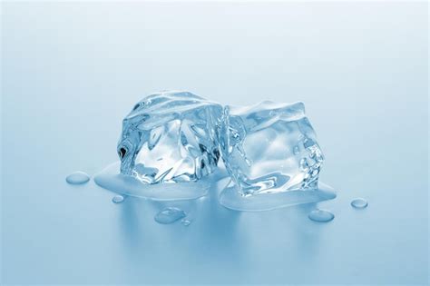 Premium Photo Two Ice Cubes Melting With Drops Of Water Taken In