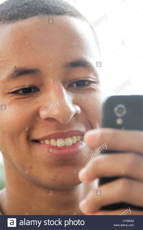 Teenage Boy Using Cell Phone Outdoors Stock Photo Alamy