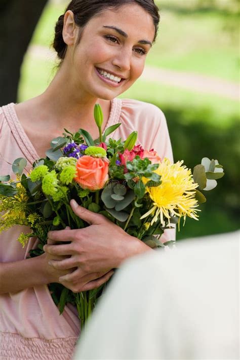Woman Holding Flowers Which She Has Been Given Stock Image Image Of Presenting Attractive