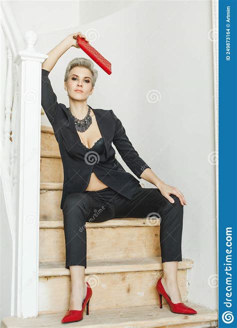 Beauty Fashion Blonde Model Woman Wearing Stylish Black Suit And Red