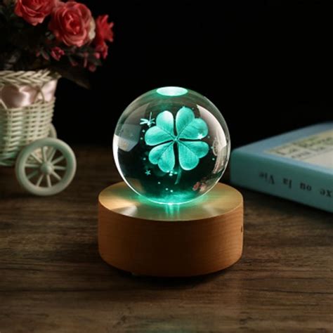 The outside of the music box sparkles. Clover Crystal Ball Music Box - ApolloBox