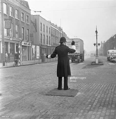 A Policeman On Point Duty At The Junction Of Commercial Road With The