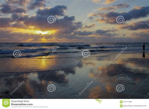 Panoramic Scene Of Ocean Sunset With Clouds Reflected On Wet Beach And