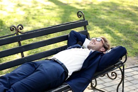 Handsome Young Businessman Resting On Bench In Park Stock Photo Image