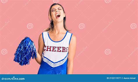 Young Beautiful Woman Wearing Cheerleader Uniform Angry And Mad Screaming Frustrated And Furious