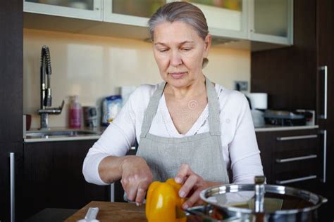 Mature Woman In Kitchen Preparing Food Stock Photo Image Of Cooking