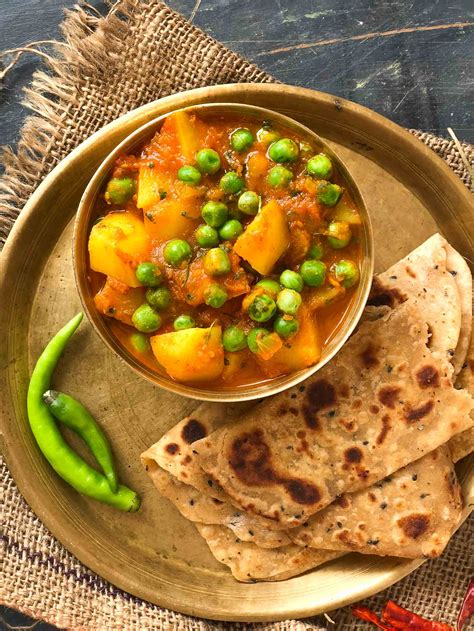 Aloo Matar Sabzi Recipe Potatoes Peas In Tomato Gravy By Archana S