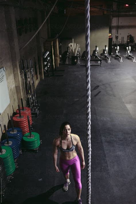 Active Fit Mixed Race Woman Training Hard With Ropes In Workout Gym By Stocksy Contributor
