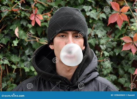 Portrait Of A Young Man He Blows A Bubble With Chewing Gum Stock Image