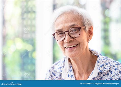 Close Up Asian Elderly Woman In Glasses Showing Healthy Straight Teeth Portrait Senior Woman