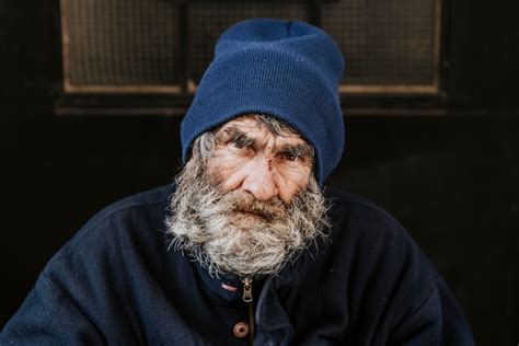 Free Photo Front View Of Homeless Man With Beard