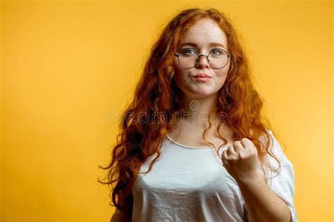 Young Pretty Ginger Woman Shows Fist With Angry Or Aggressive