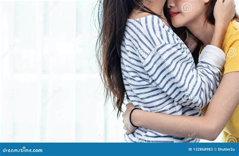 close up of two asian lesbian women looking together in bedroom stock image image of happy
