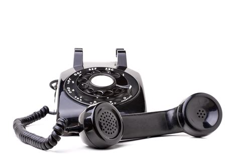 An Old Black Vintage Rotary Style Telephone Off The Hook Isolated Over