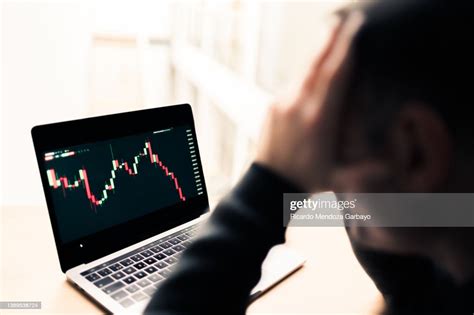 Pensive And Sad Man Watching The Graph Crash High Res Stock Photo