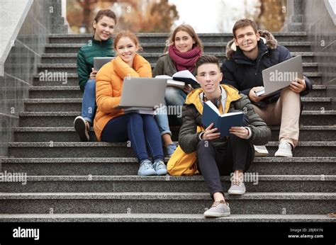 Group Of Teenagers Studying On Stairs Outdoors Stock Photo Alamy