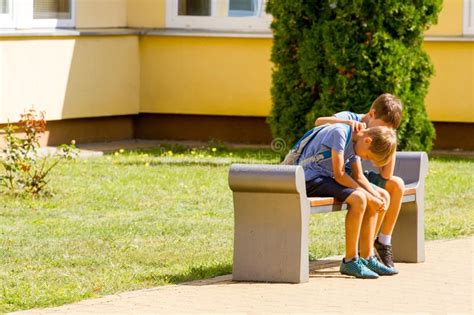 Kid Comforting Consoling Upset Sad Boy In School Yard Stock Image
