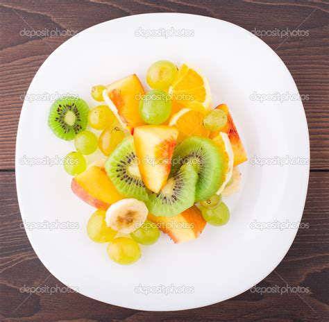 Assortment Of Sliced Fruits On Plate — Stock Photo © Vankad 31053635