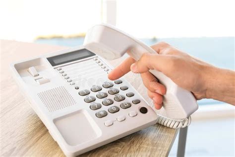 Man Dialing Number On Telephone At Table Stock Photo Image Of
