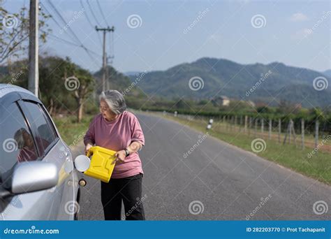 the car ran out of gas and stalled beside the road in suburbs and an elderly asian woman used a