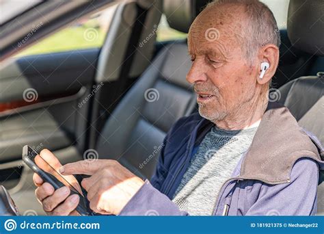 Happy Cheerful Elderly Man Traveller Sitting In Car And Choosing Place