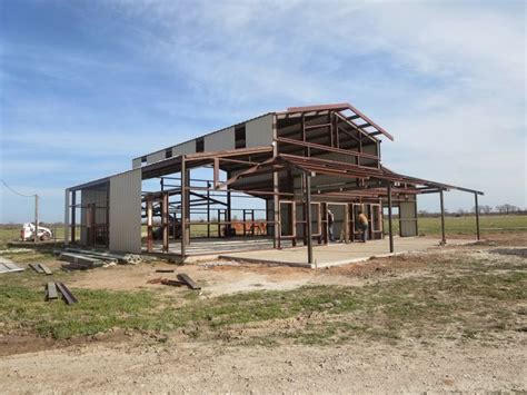 A Large Metal Building Sitting On Top Of A Dirt Field