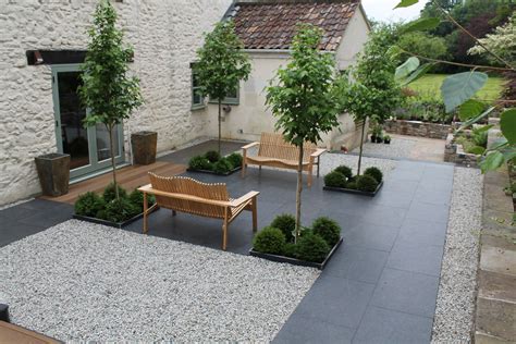 A Beautiful Country Courtyard With Paved Terrace And Gravel With Four
