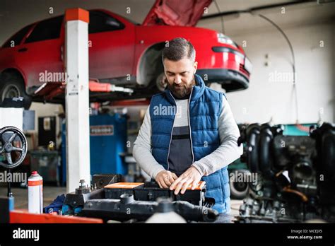 Man Mechanic Repairing A Car In A Garage Stock Photo Alamy