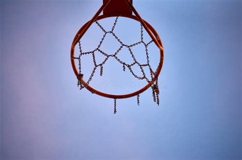 Hoop Of An Orange Basketball Net With A Chain By Net And Damaged Stock