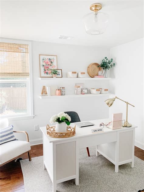 A Home Office With White Walls And Wood Floors