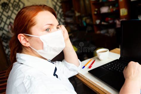 redhead girl in face mask looking out the window stock image image of face female 188310855