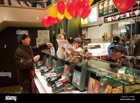 Employees of a McDonald's restaurant in New York serve customers Stock
