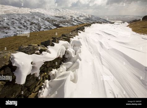 Massive Snow Drifts Block The Kirkstone Pass Road Above Ambleside In