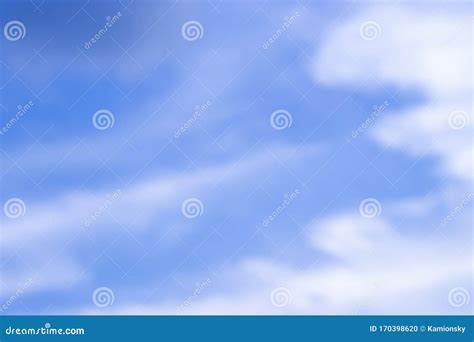 Abstract Blurred Background Blue Sky With White Clouds In Sunlight