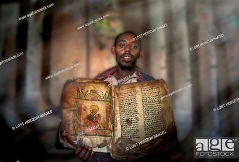 Priest Showing An Ancient Religious Book In An Orthodox Monastery