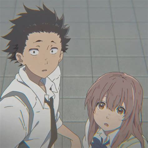 Two Anime Characters Standing Next To Each Other In Front Of Tile
