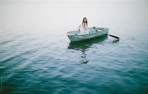 Lonely Girl Floats Alone In A Row Boat On A Foggy New England Morning