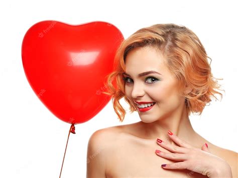 Premium Photo Playful Attractive Blond Girl Holding Red Heart Balloon Isolated On White