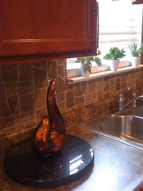 Tiled kitchen backsplashes give a custom look to a home and stand up better than a wallpapered backsplash according to an angie's list magazine report. Wallpaper backsplash. 27.00 at Menards. Looks like stone, but much easier and cheaper. (With ...