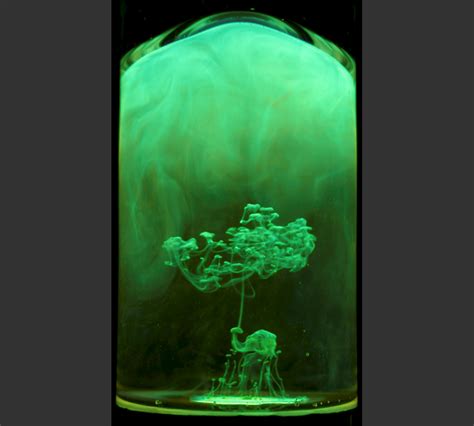 An Upside Down Image Of Green Highlighter Dropped Into Water Showing