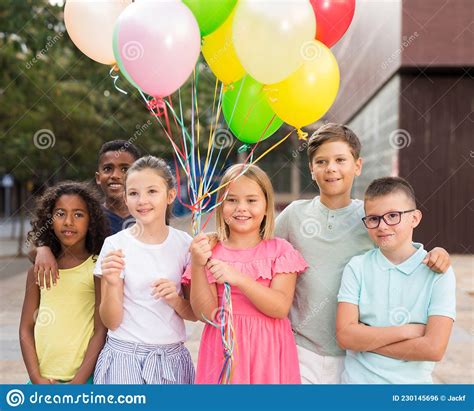 Cheerful Happy Tween Children With Colorful Balloons On City Street