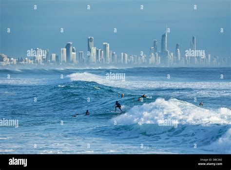 Surfer Riding Wave With Surfers Paradise Skyline In Background