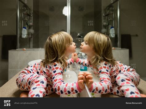 Little Girl Kissing Herself In The Bathroom Mirror Stock Photo Offset