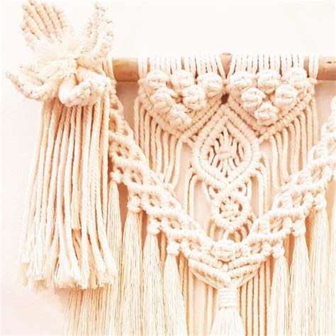 A White Wall Hanging With Tassels On It