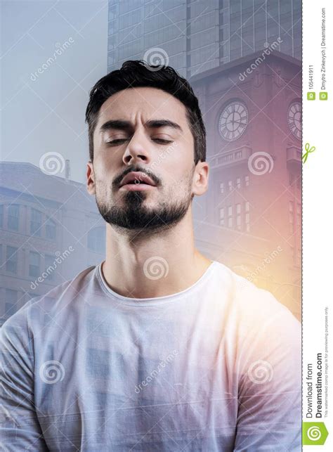 Serious Young Man Closing His Eyes While Remembering Important