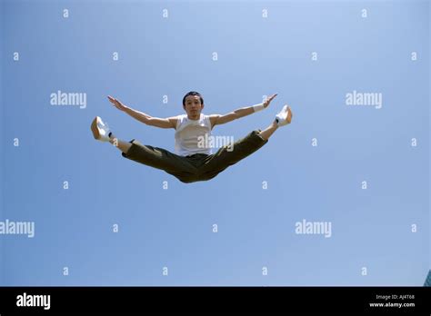 Young Man Jumping And Doing Splits In Mid Air Stock Photo Alamy