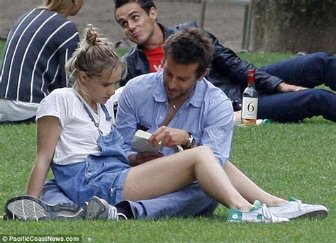 Bradley Cooper Struggles To Read His Book As Suki Waterhouse Sprawls Across Him In Parisian Park